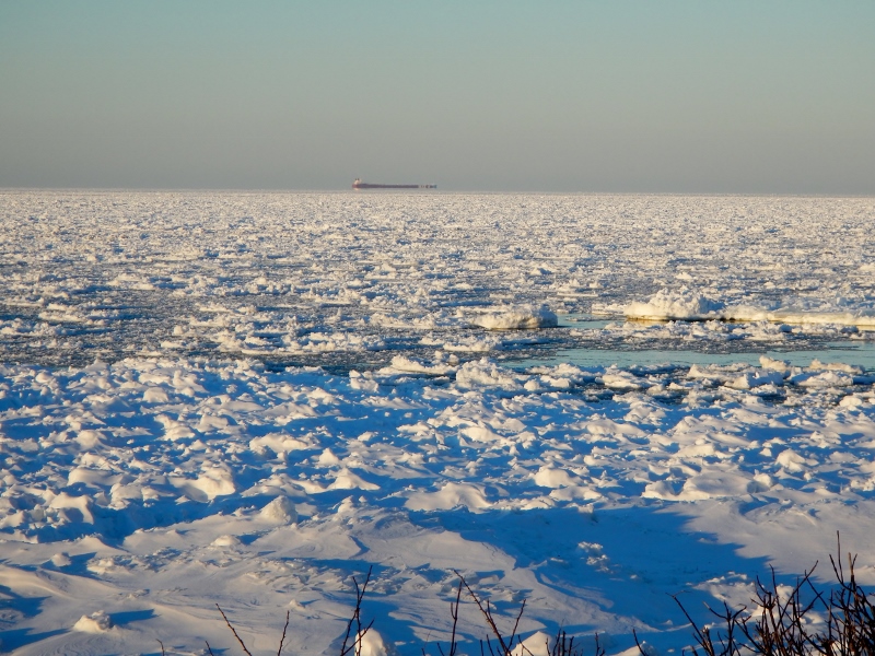 A lake freighter makes it's way through the winter ice of
          Lake Huron