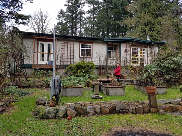 2018 Xmas BC Kathy poses in front of R&T home on
        Melrose