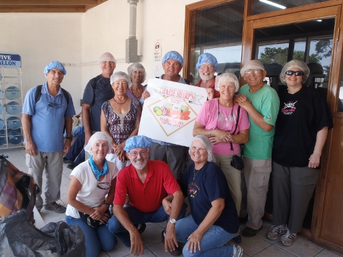 The
              Cruisers that toured Maria Sharps canning facility pose
              for a photo